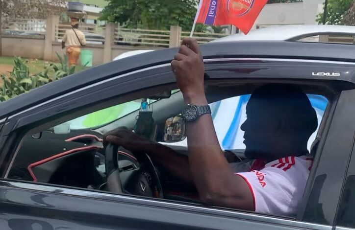 Arsenal supporters waving club flags during Premier League title celebrations in Abeokuta, Ogun State.
