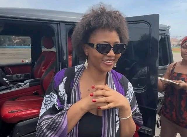 Regina Daniels looking amazed beside a luxury Brabus Mercedes-Benz G63 AMG reportedly gifted to her.